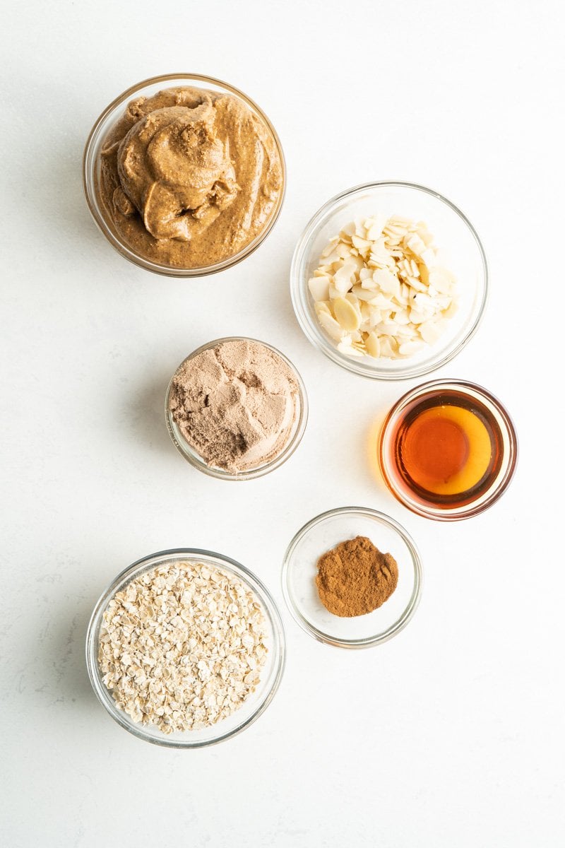 Ingredient for an energy balls recipe made with chocolate protein powder, almond butter, espresso and oats.
