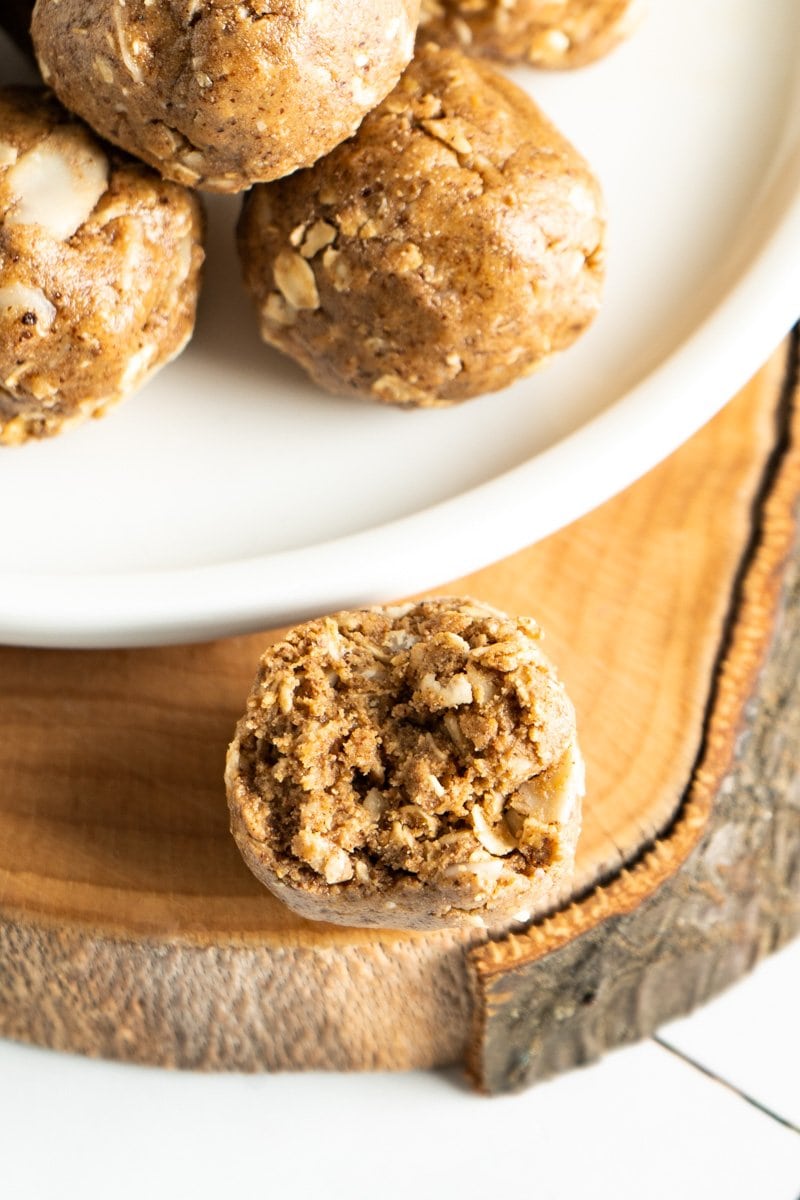 An almond butter protein ball with a bite missing.