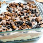 A close up showing the layers of a no bake chocolate peanut butter dessert.