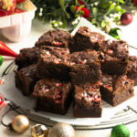 Peppermint brownies on a cooling rack on a holiday table.