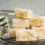 A cooling rack stacked with shortbread cookies.