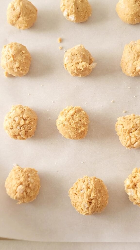 Rolled old-fashioned peanut butter balls waiting to be dipped in chocolate.