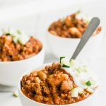 Three bowls of the best turkey chili recipe on a white tile table