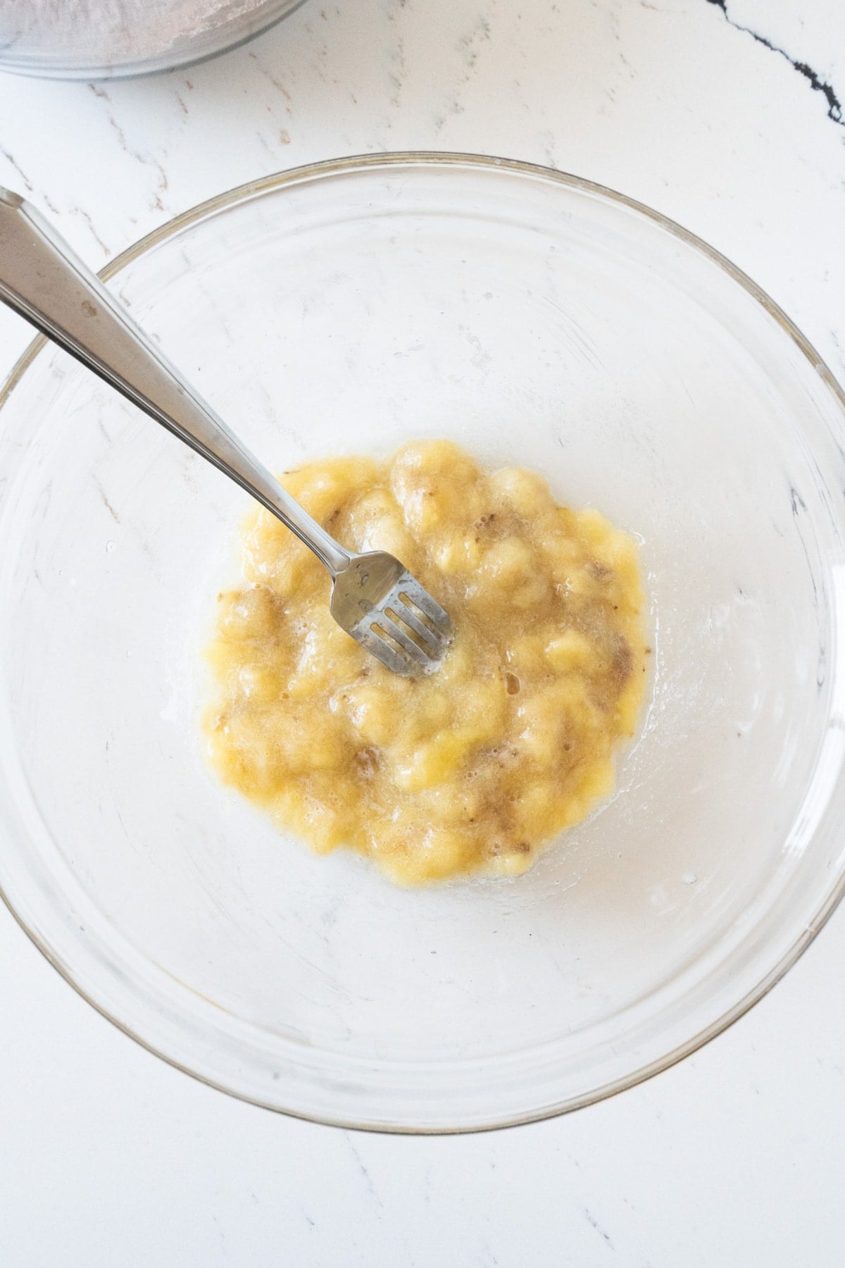 A bowl of mashed bananas and egg.