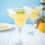 Two simple margaritas using the juice of Meyer Lemons in margarita glasses rimmed with salt, sugar and lemon zest.