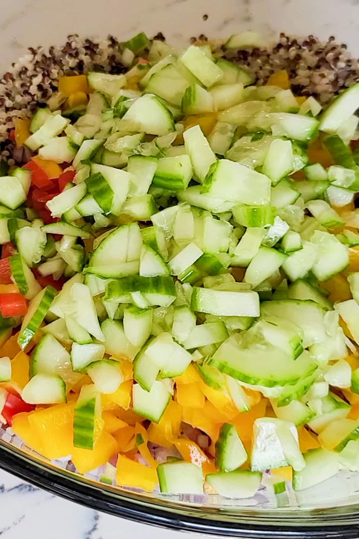 Ingredients for a quinoa lentil salad in a bowl.