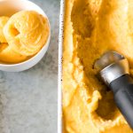 Overhead shot of basil peach sorbet in a white loaf pan with an ice cream scoop and a small bowl beside.