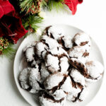 Close up of a chocolate crinkle cookie with a bite taken out of it