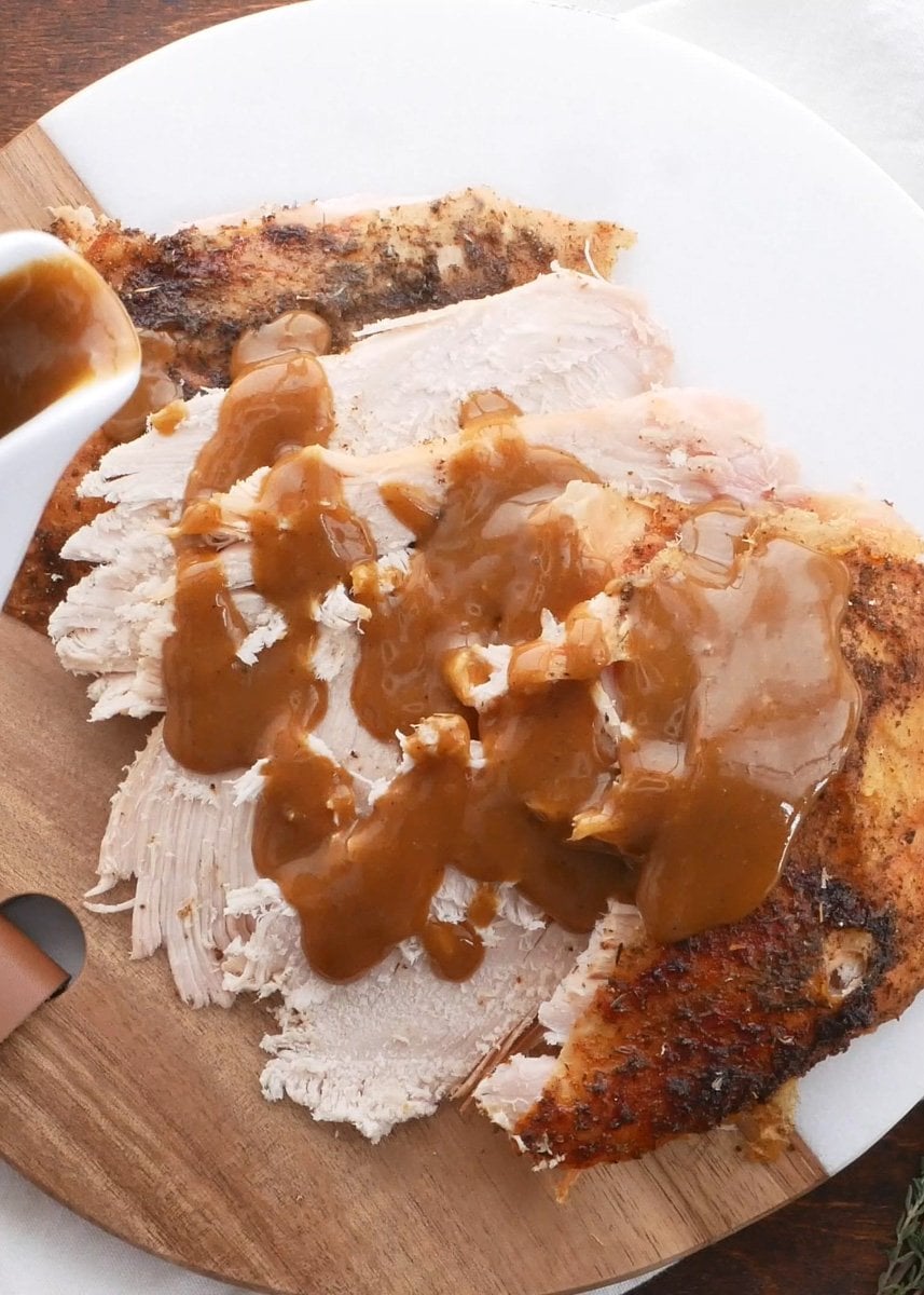 A Convection roast turkey sliced with gravy.