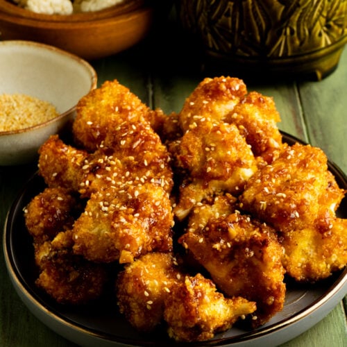 A plate of air fryer cauliflower wings on a table.