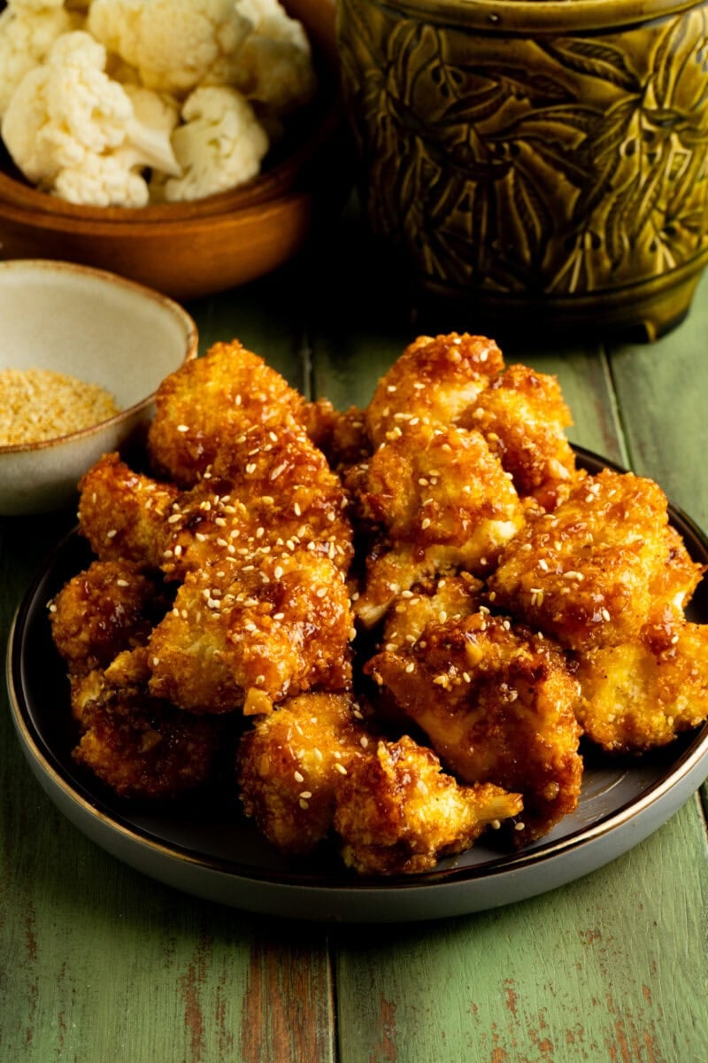 A plate of air fryer cauliflower wings on a table.
