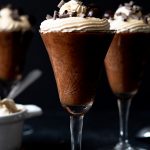 Close up of a Baileys chocolate mousse dessert with whipped topping and chocolate shavings.
