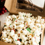 Christmas Popcorn with White Chocolate and sprinkles in festive packaging.
