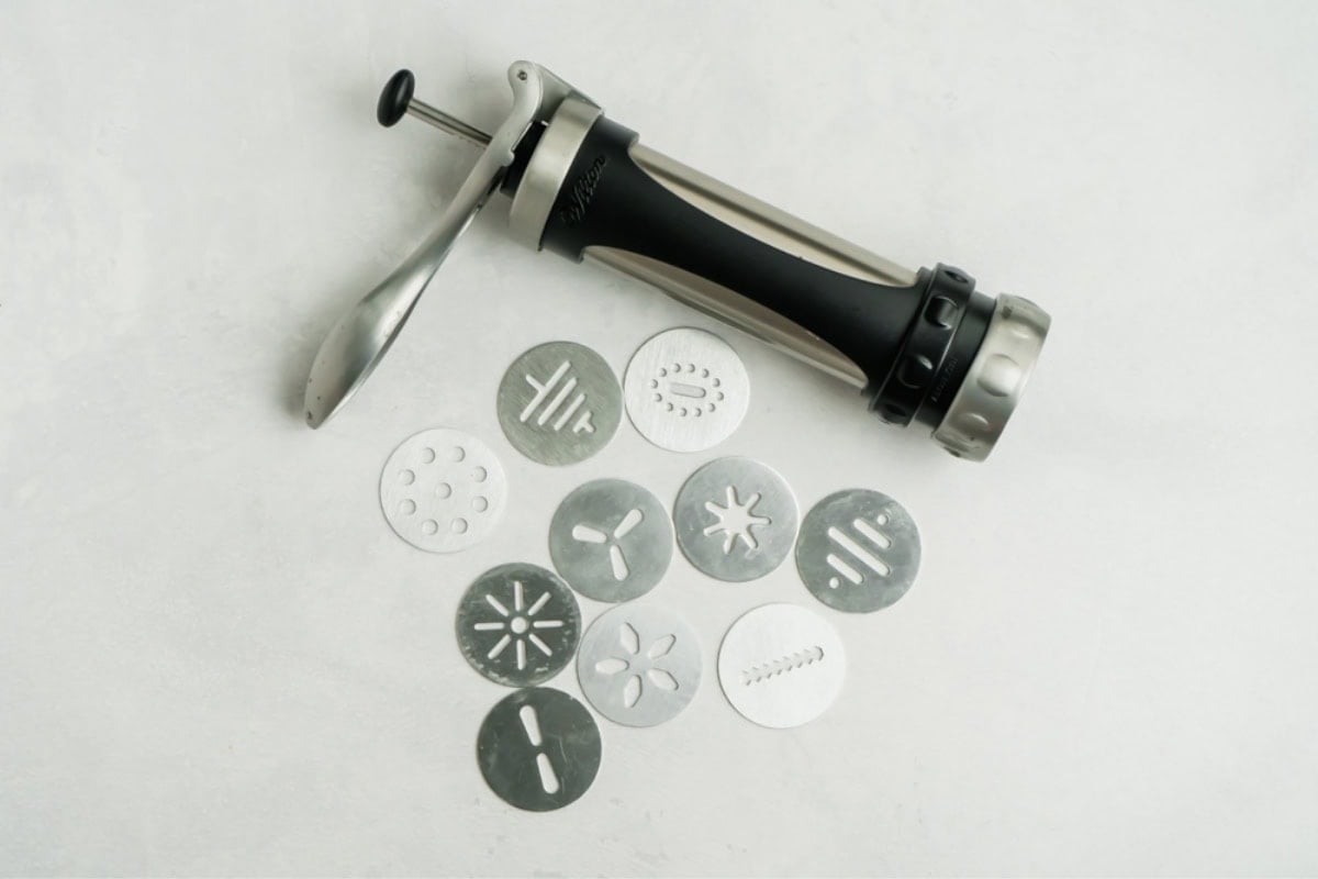 Picture of a cookie press and it's available disks.