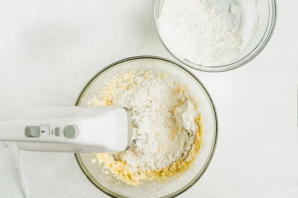 Flour being gradually beaten into a cookie dough.