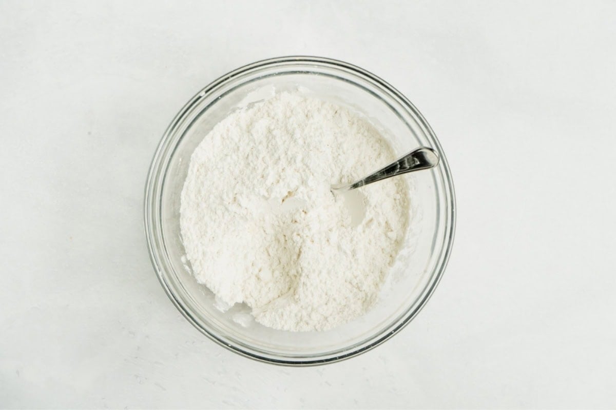 Flour and salt in a bowl being mixed.