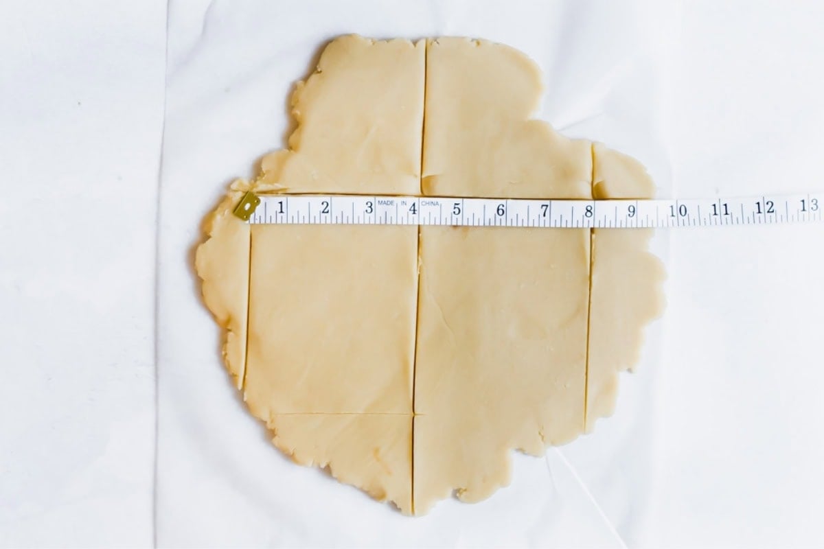 rolled out dough being measured and cut.