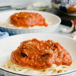 Marinara Sauce piled high on top of a bed of pasta.
