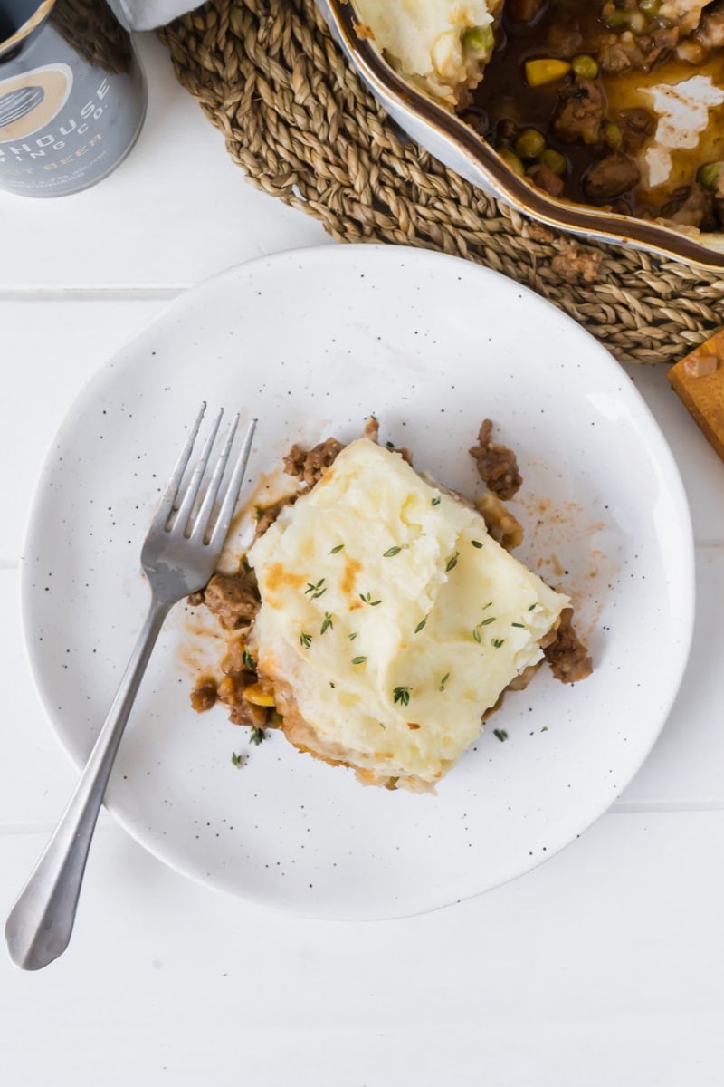 The best cottage pie recipe ever on a plate with a fork.