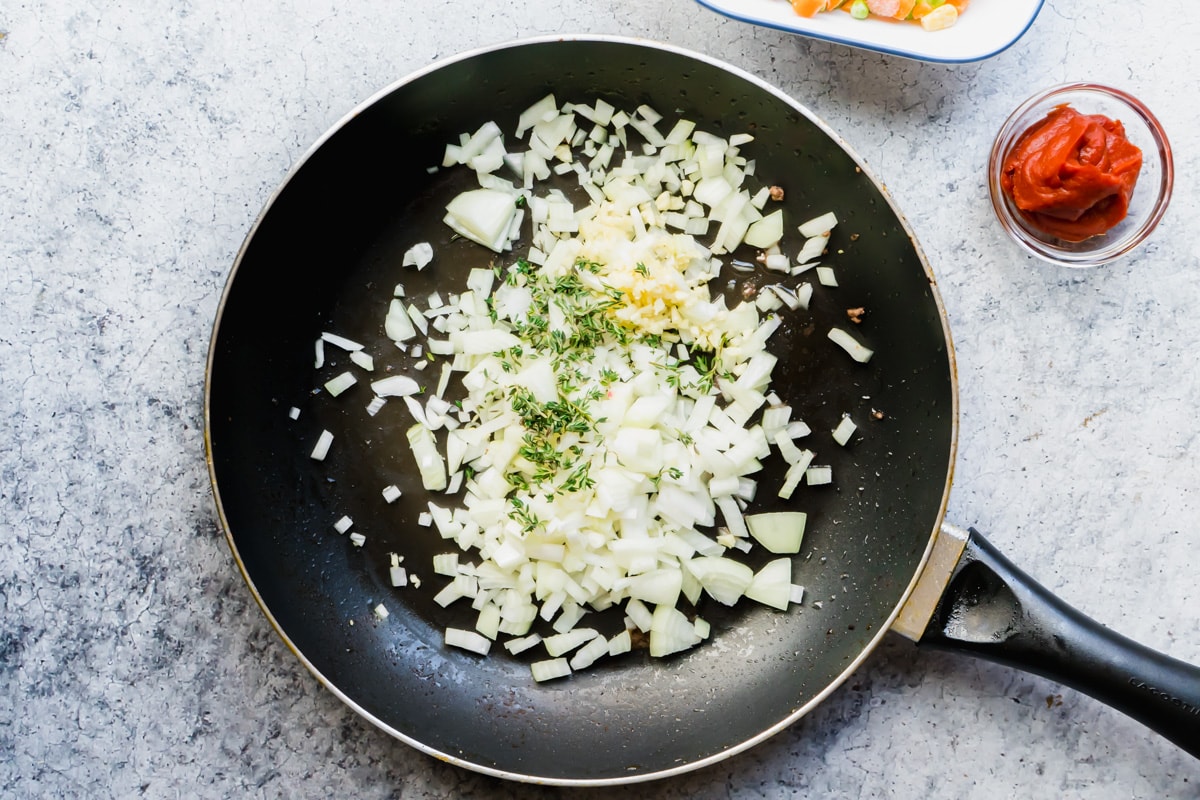 Onions, garlic and thyme in a pan