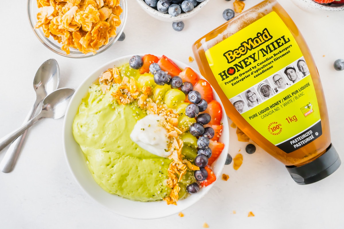 A smoothie bowl idea made with avocado and spinach as well as fresh fruit