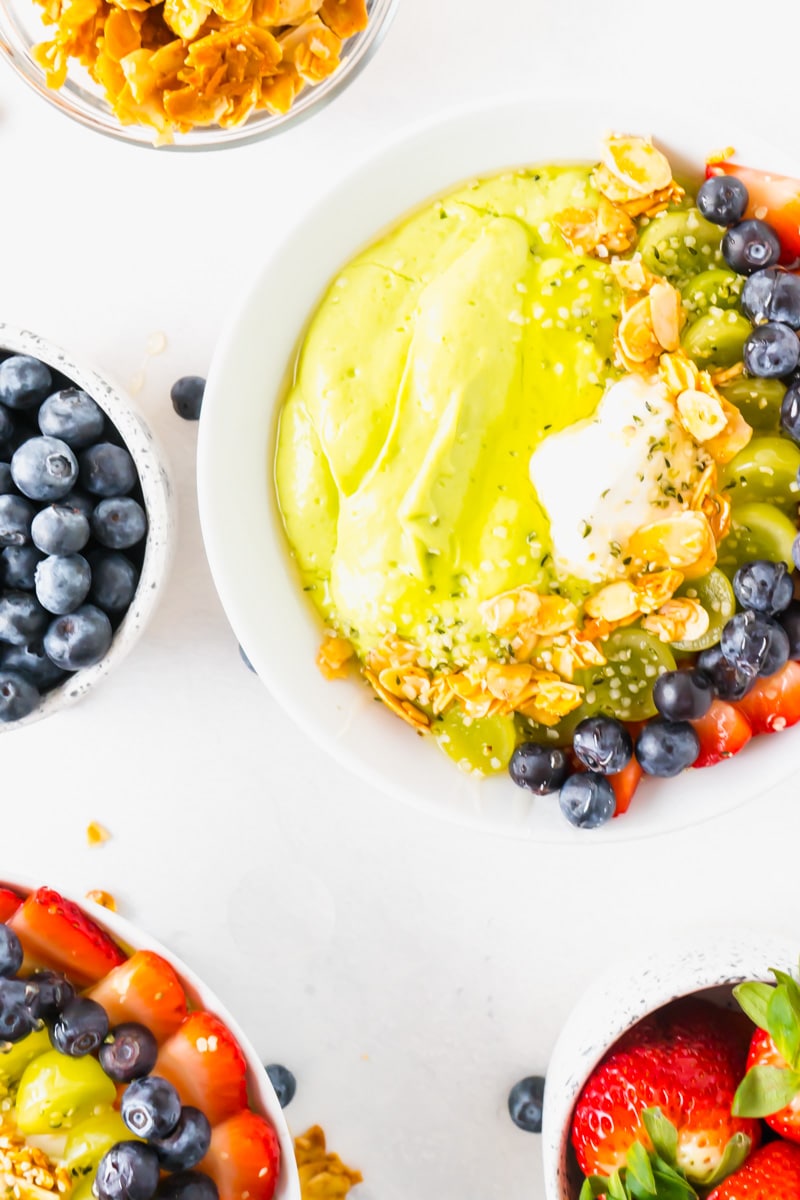 A breakfast smoothie bowl topped with berries and almonds