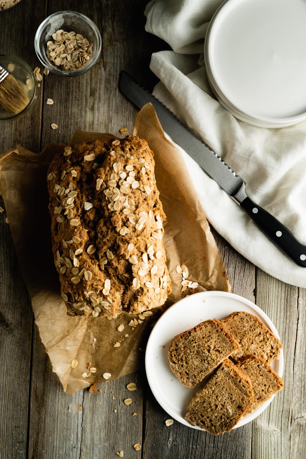 No Yeast Beer Bread recipe on a table with a plate of slices.