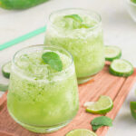Two glasses filled with a frozen cucumber mojito recipe