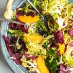 A bowl of frisse and orange salad