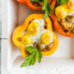Breakfast stuffed peppers in a baking dish.