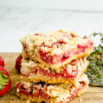 A stack of dessert squares made with strawberries.