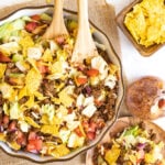 Overhead of a taco salad recipe topped with crushed tortilla chips