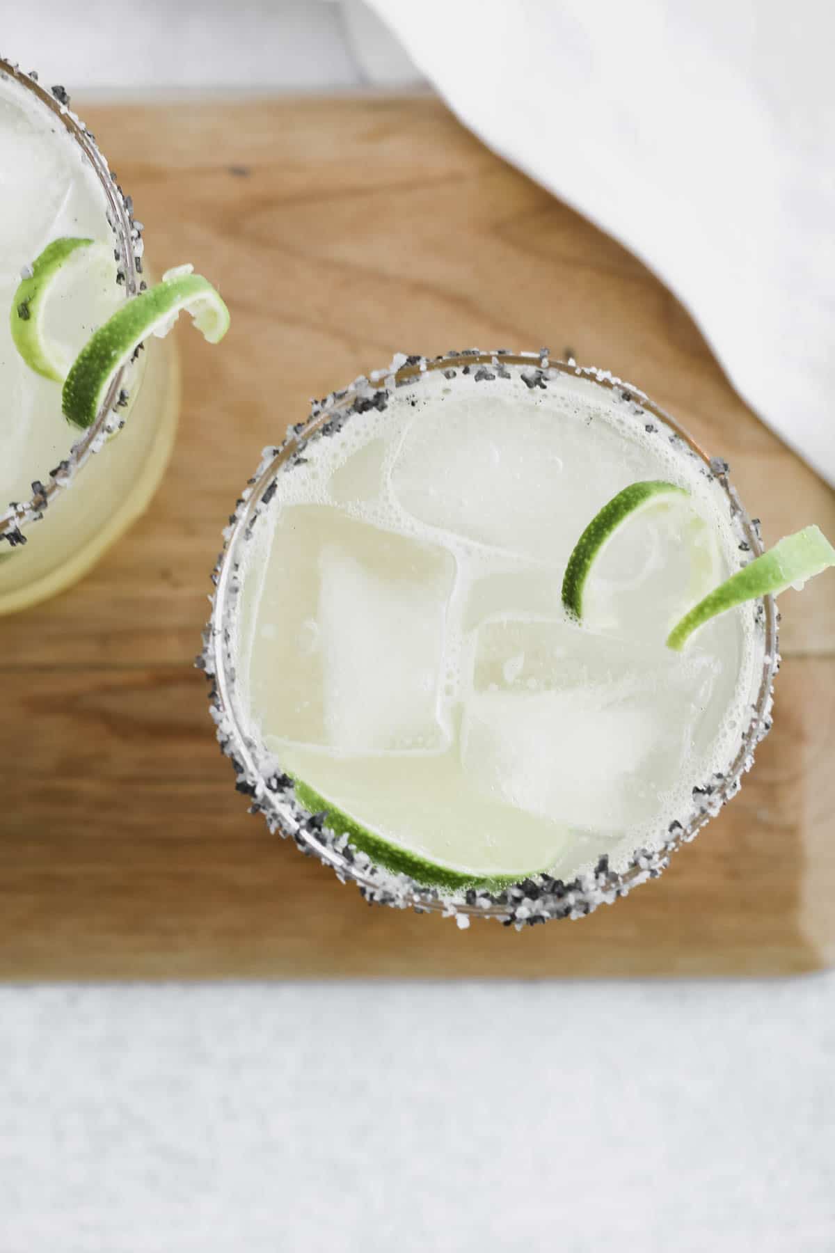 A skinny margarita in a salt rimmed glass with lime.