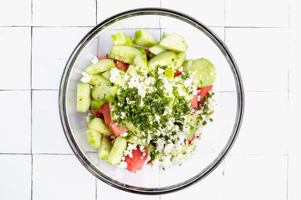 A bowl of watermelon, cucumber and mint with feta for a salad