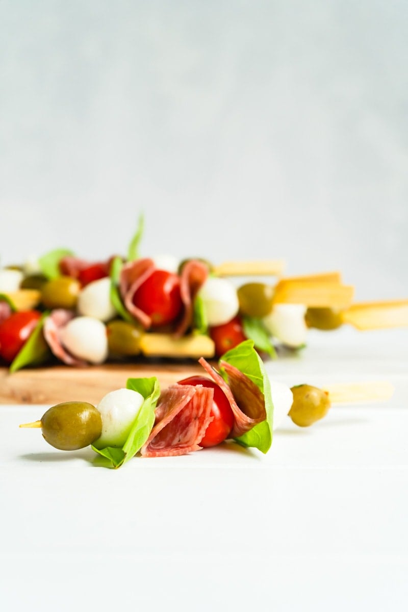 A single antipasto appetizer skewer with more in the background