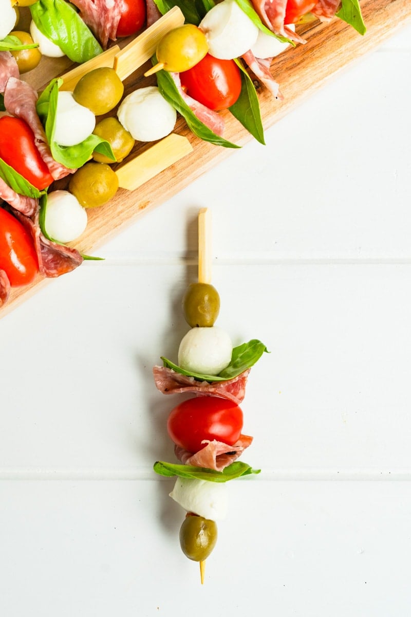 An antipasto skewer on a white table.