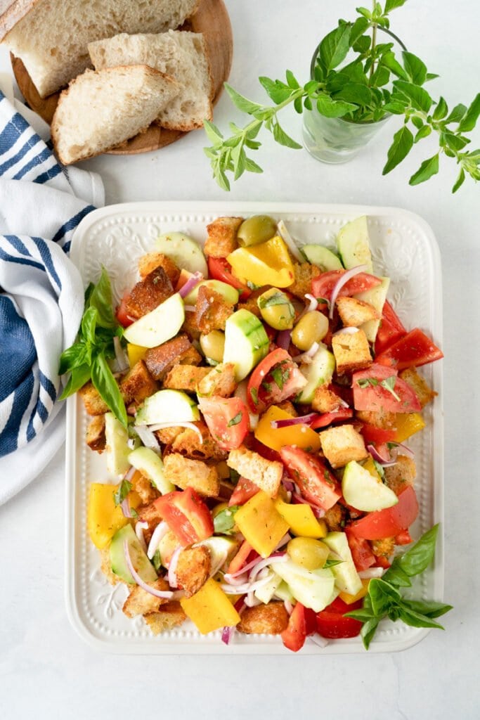 A healthy dish, this Panzanella Salad is sitting on a platter.