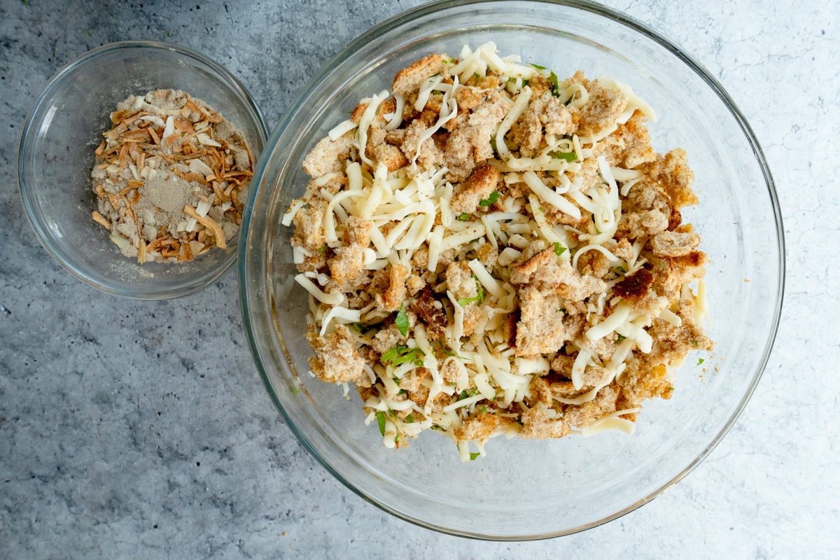 A bowl of bread crumbs with cheese and parsley