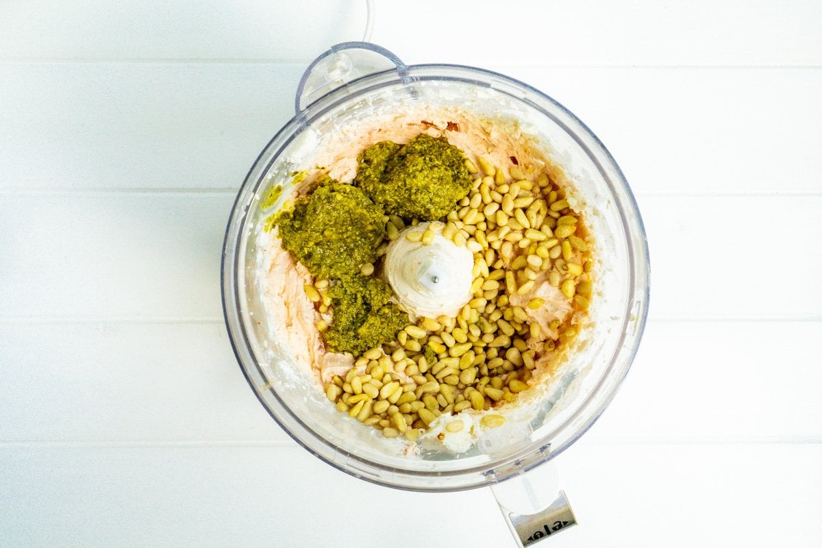 A food processor filled the cream cheese spread, pesto and pine nuts.