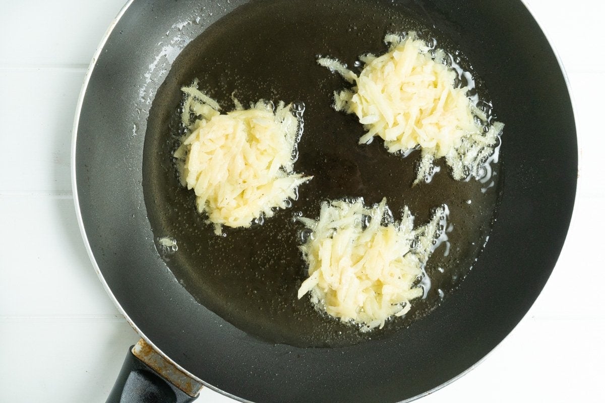 frying potato cakes in a frying pan