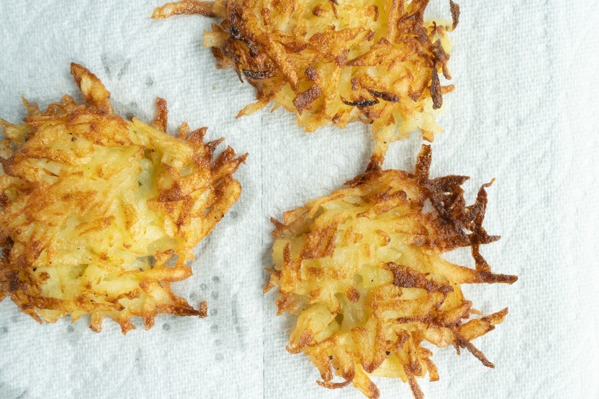 fried potato cakes on a paper towel