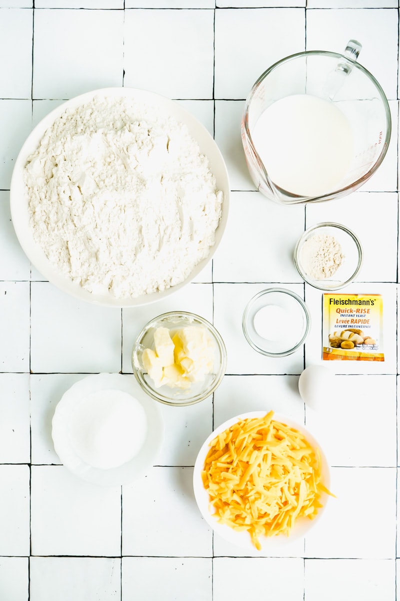 The ingredients needed to make a recipe for cheddar cheese buns.