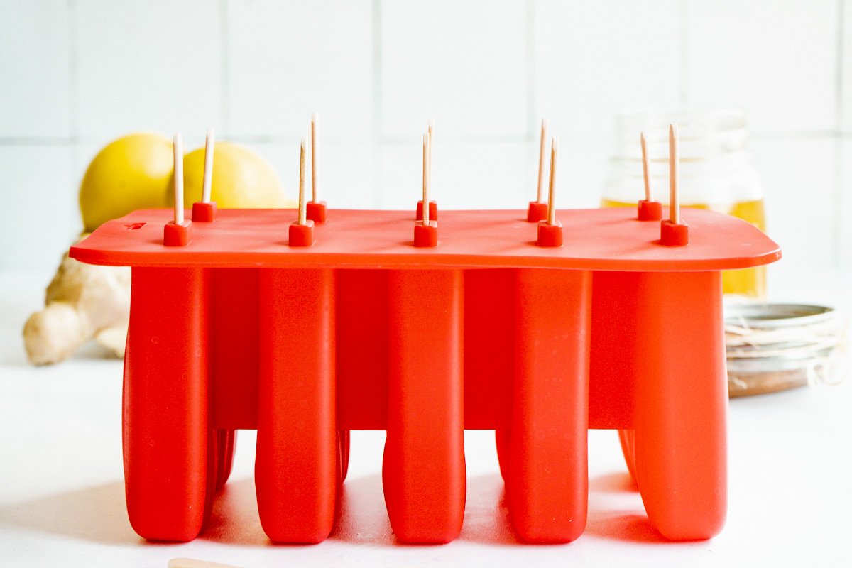 A tray of popsicles in their mould.