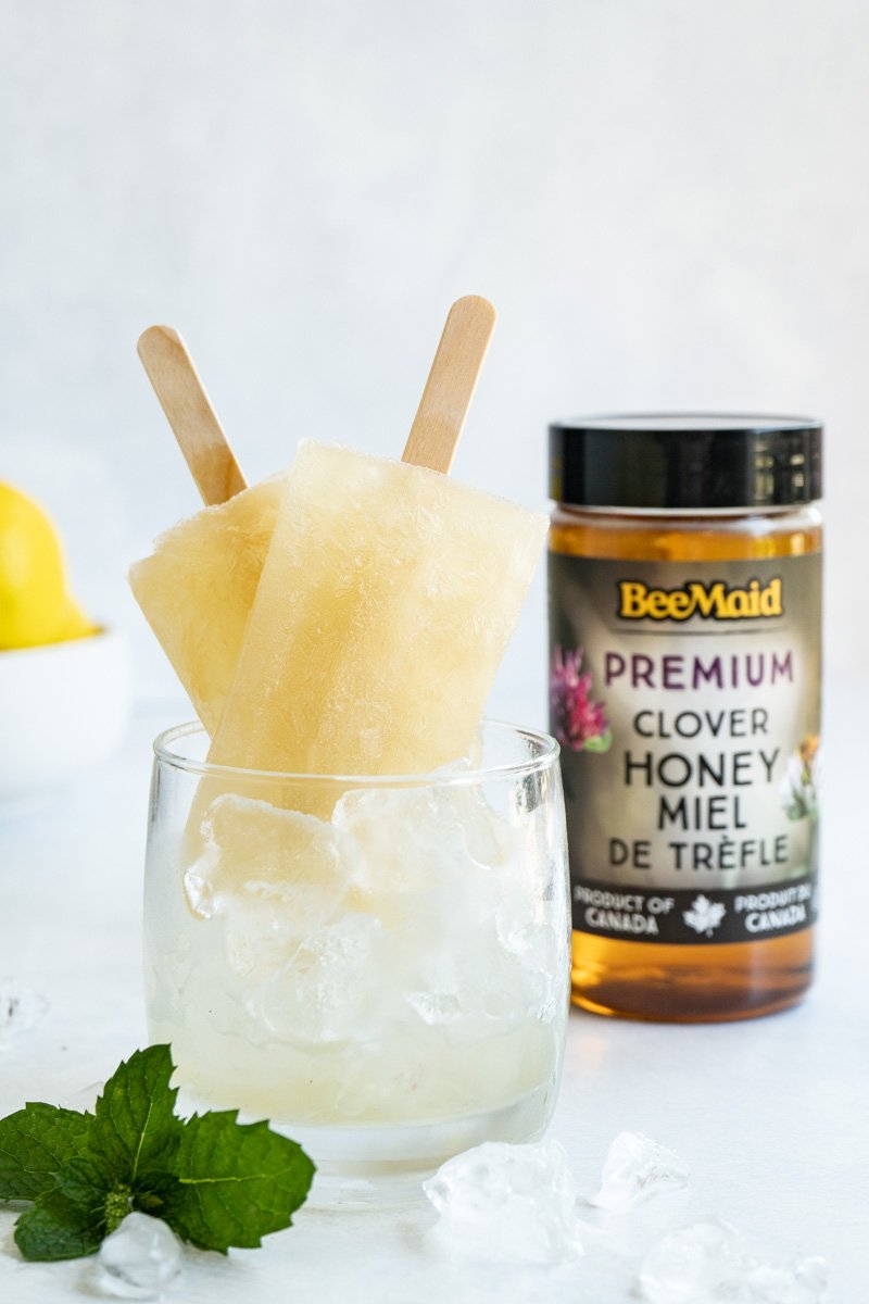 Two homemade coughsicles in a cup of ice.