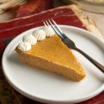 A slice of easy crustless pumpkin pie on a plate.
