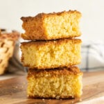 A tower of dairy free cornbread on a cutting board.