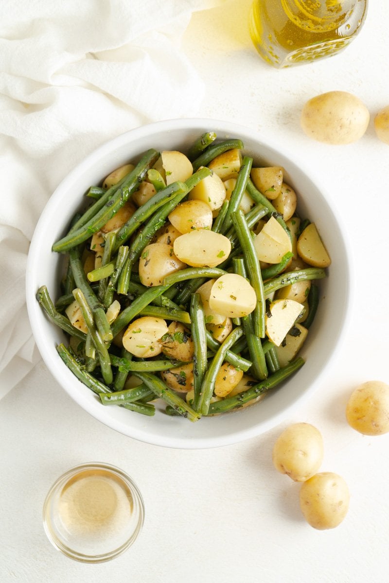 A bowl of green beans with potatoes