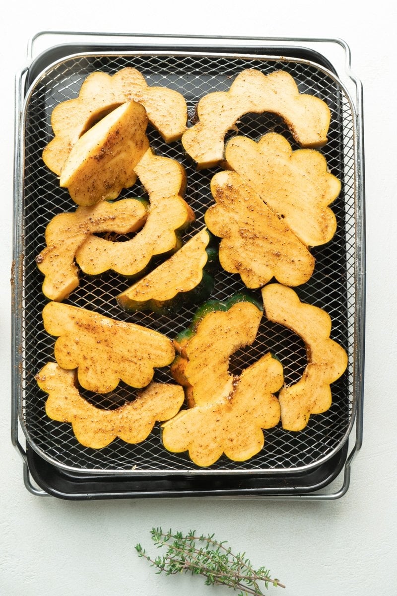 Acorn sliced in air-fryer basket