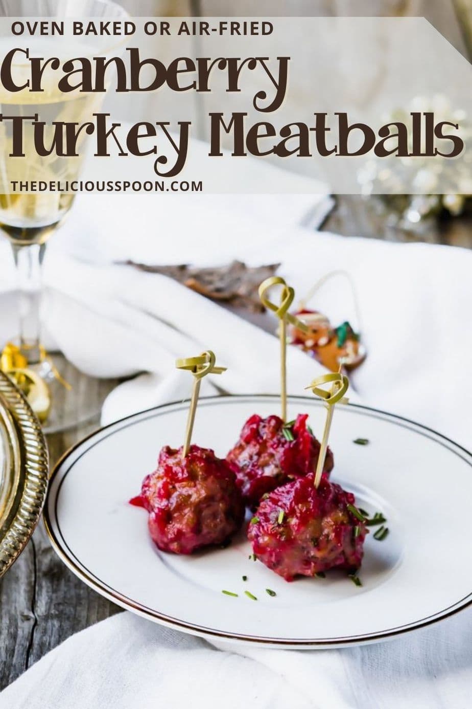 Pinterest pin showing baked or air-fried turkey meatballs made with orange cranberry sauce.