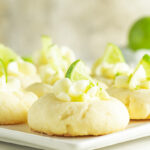 Close up of a lime meltaway cookie topped with a tiny lime wedge.